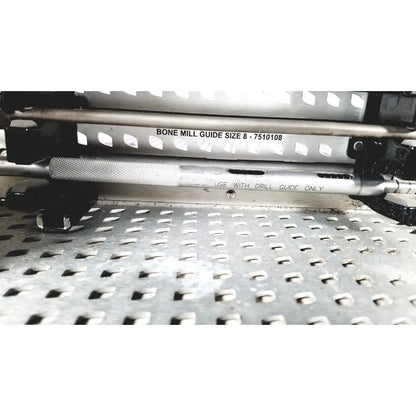 Silver metallic bone mill guide with textured grip and engraved markings for precise drilling in nuvasive speed innovation coroent xl-fixation tray
