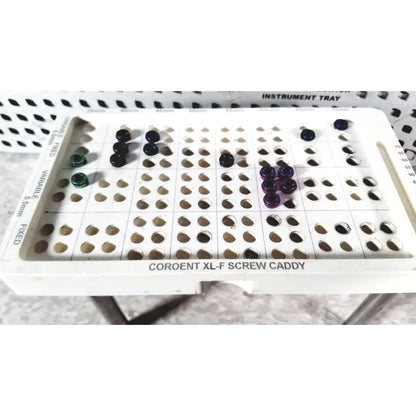 White plastic screw caddy labeled coroent xl-f screw caddy holding colored screws in nuvasive speed innovation coroent xl-fixation tray
