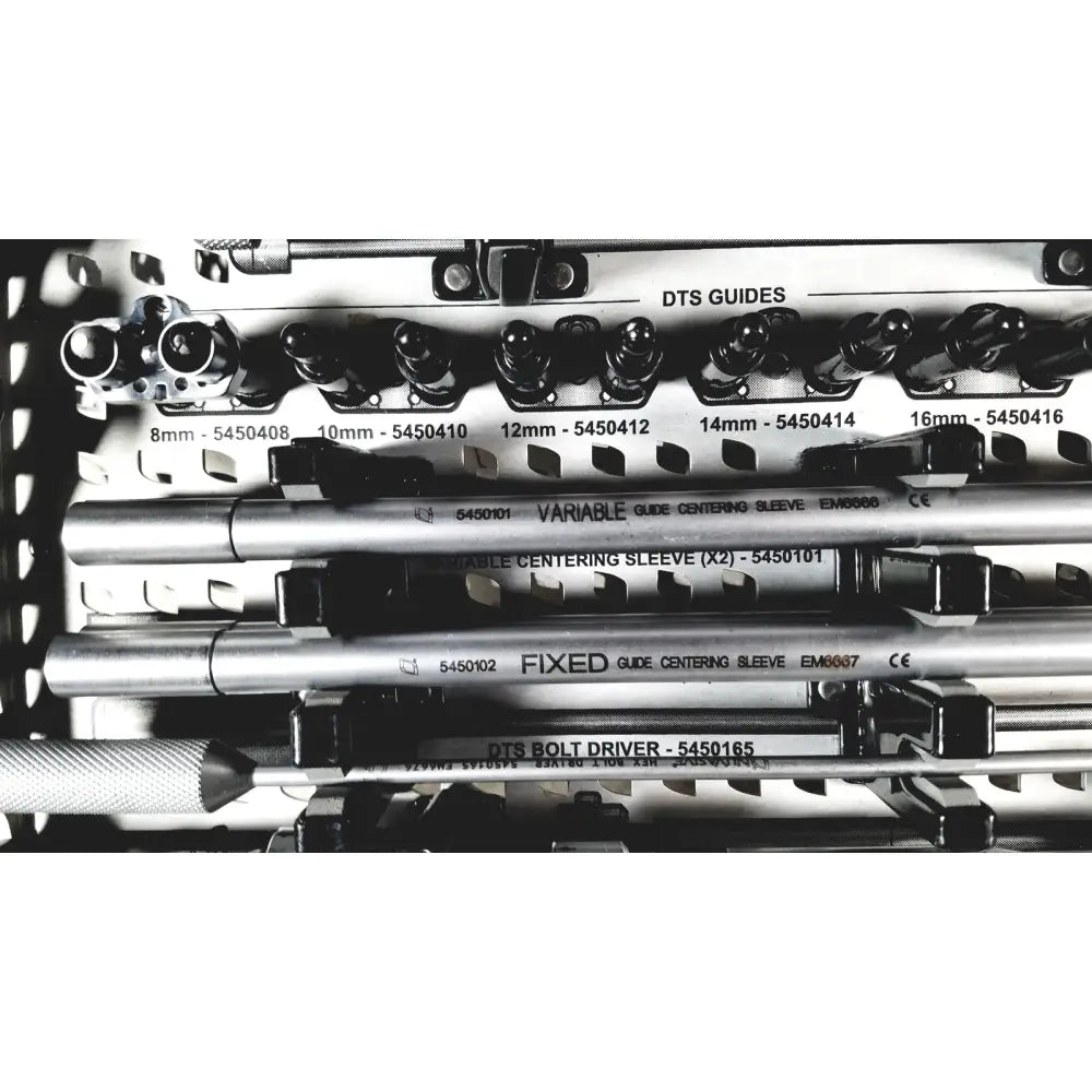 Silver metallic dts guide centering sleeves and bolt drivers arranged in nuvasive speed innovation coroent xl-fixation instrument tray