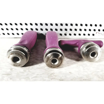 Three purple-handled metallic-tipped grooming tools with textured grips in nuvasive speed innovation coroent xl-fixation tray