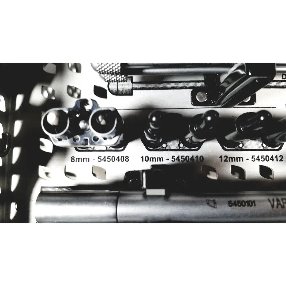 Silver surgical drill bits with labeled sizes arranged in a metal tray for nuvasive speed innovation coroent xl-fixation
