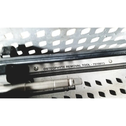 Stainless steel osteophyte removal tool with metallic finish and engraved label in nuvasive speed innovation coroent xl-fixation tray
