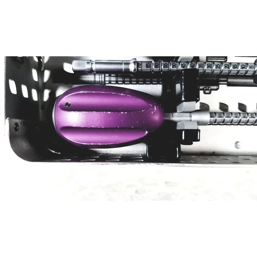 Nuvasive speed innovation coroent xl-fixation instrument tray with purple glossy plastic handle and two black screws on top