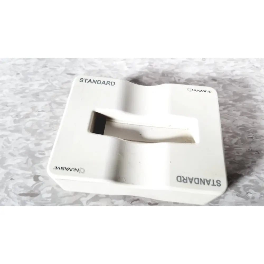 White plastic nuvasive speed innovation coroent xl-fixation standard tissue box with rectangular opening and embossed branding