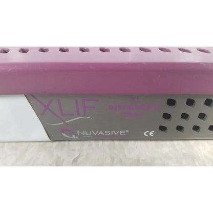 Pink and gray Nuvasive XLIF X1 instrument tray with perforated design for organized surgical instrument storage