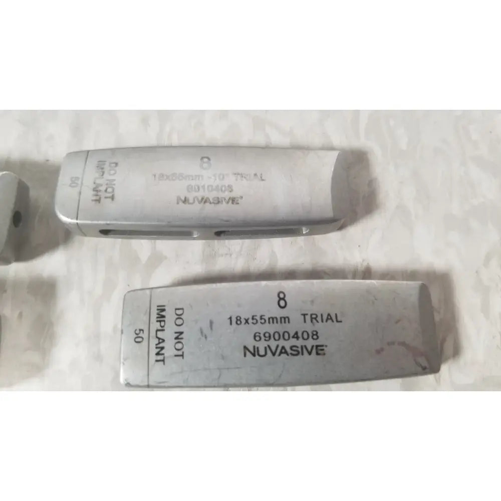 Silver metallic dental implant trial models with engraved nuvasive brand name for nuvasive xlif x1 instrument tray missing piece