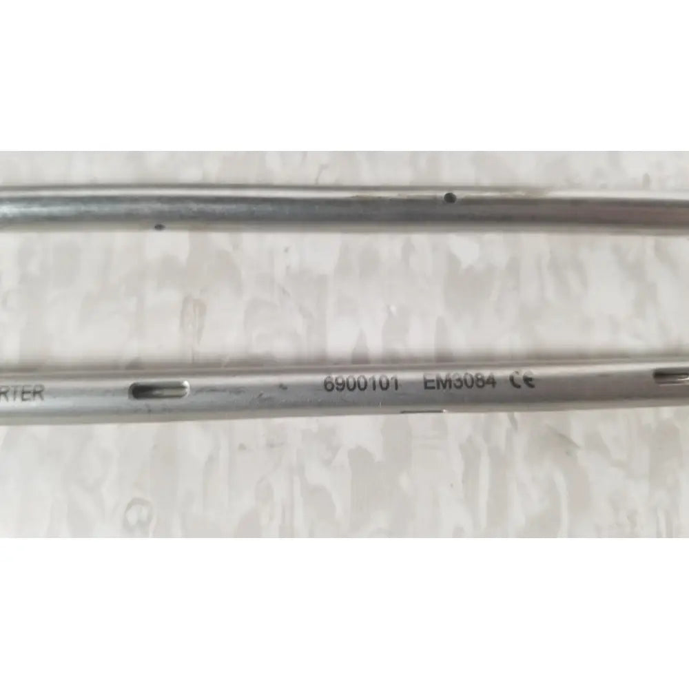 Silver metallic surgical rod with engraved 6900101 em3084 and ce markings from nuvasive xlif x1 instrument tray