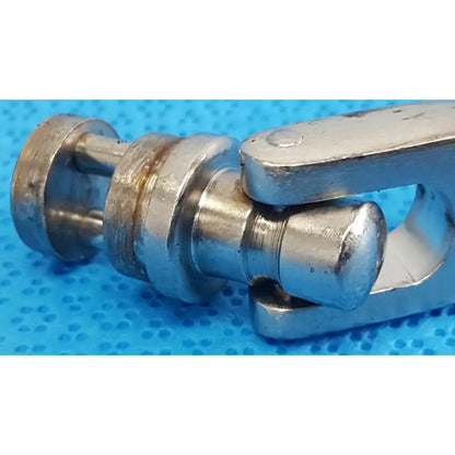 Silver metallic octobase retractor handle with machined surfaces and wear marks for surgical retractor positioning