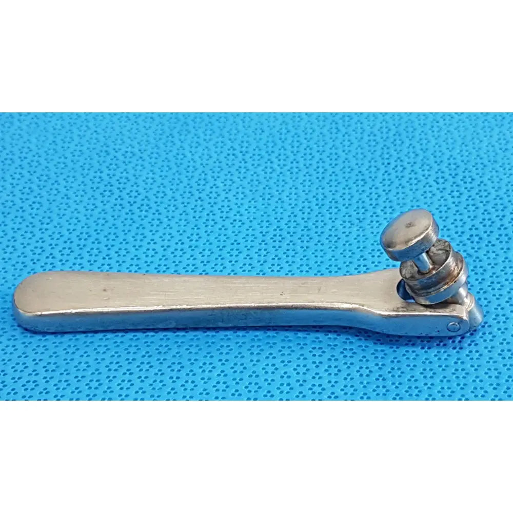 Silver-toned metal octobase retractor handle with textured handle and rounded head for surgical retractor positioning