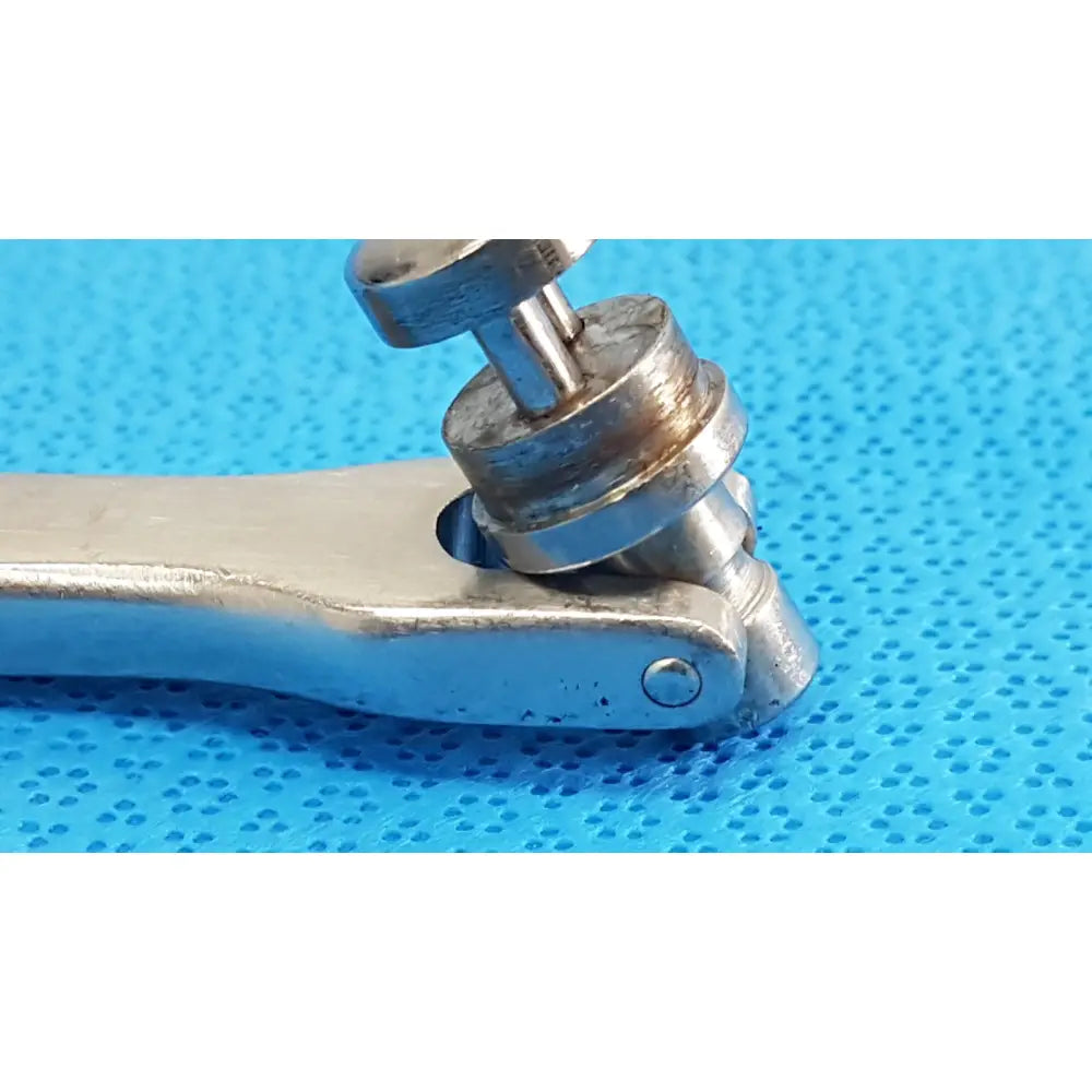 Silver-toned metal octobase retractor handle with textured grip and worn jaws for surgical retractor positioning component