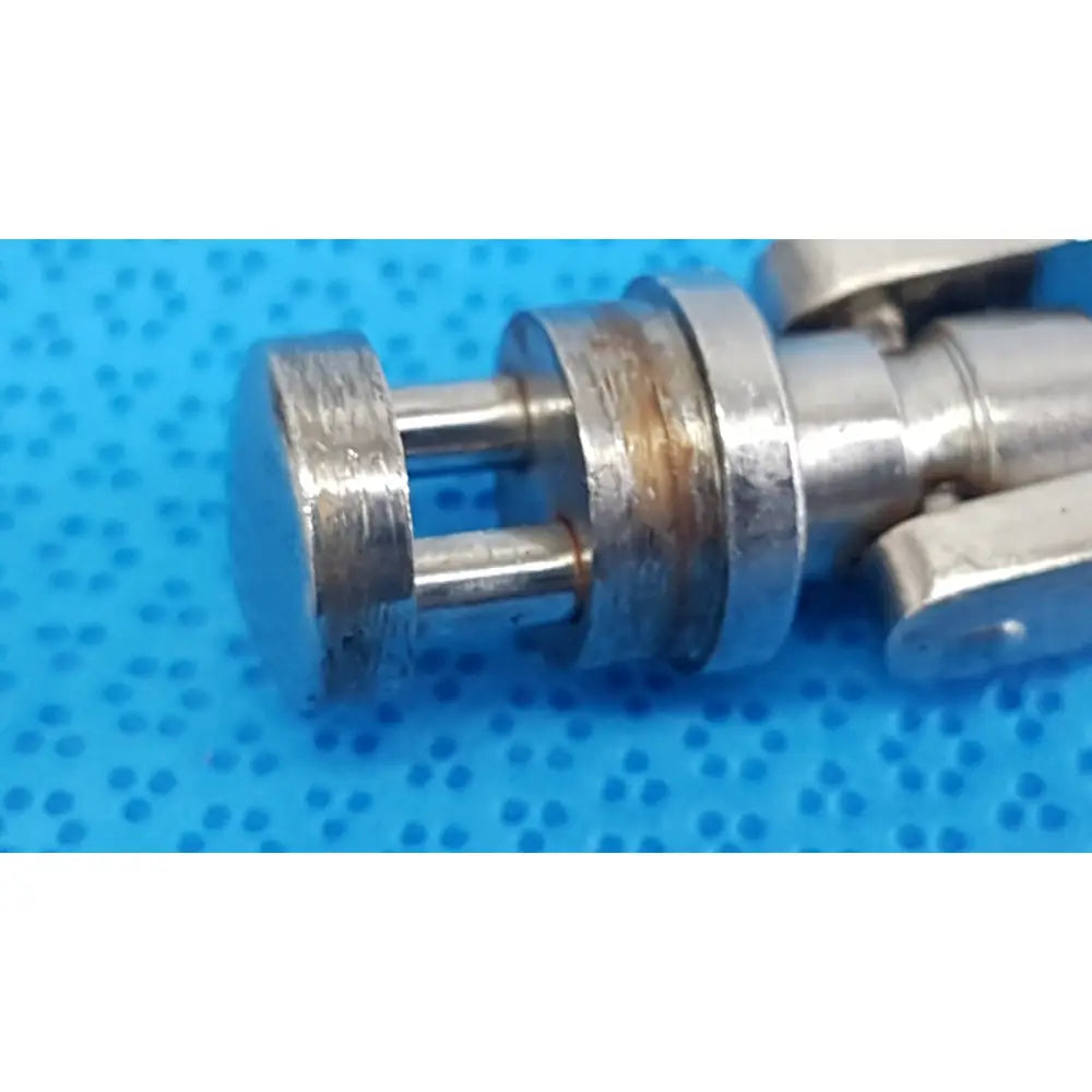 Silver-toned metal octobase retractor handle showing slight rust near joint for surgical retractor positioning component