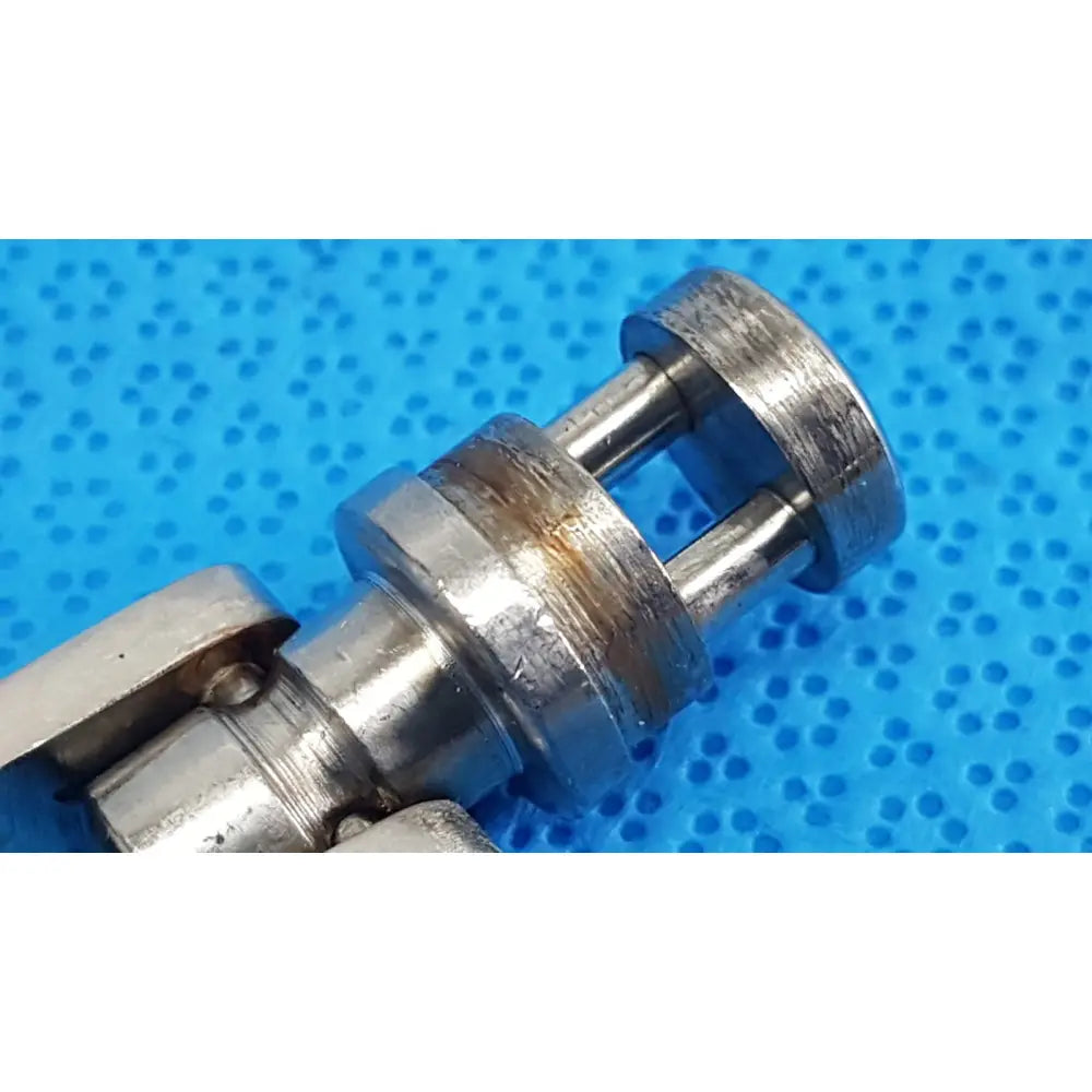 Silver-toned metal octobase retractor handle with cylindrical body and parallel rods for surgical retractor positioning component