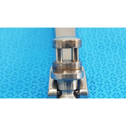 Silver-toned metal clasp with rounded top and two vertical slots for octobase retractor handle surgical positioning component