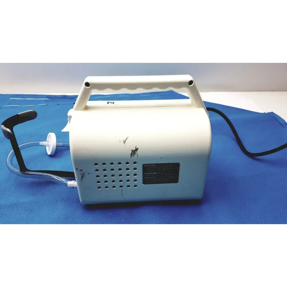 White plastic Ohio Care-E-VAC 3 portable suction pump medical unit with black handle and tubing for medical use