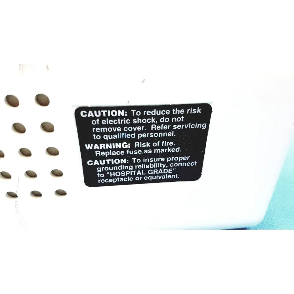 White plastic ohio care-e-vac 3 portable suction pump medical unit with black safety warning label on back side