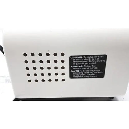 White plastic back side of ohio medical care-e-vac 3 portable suction device with black caution label and ventilation holes