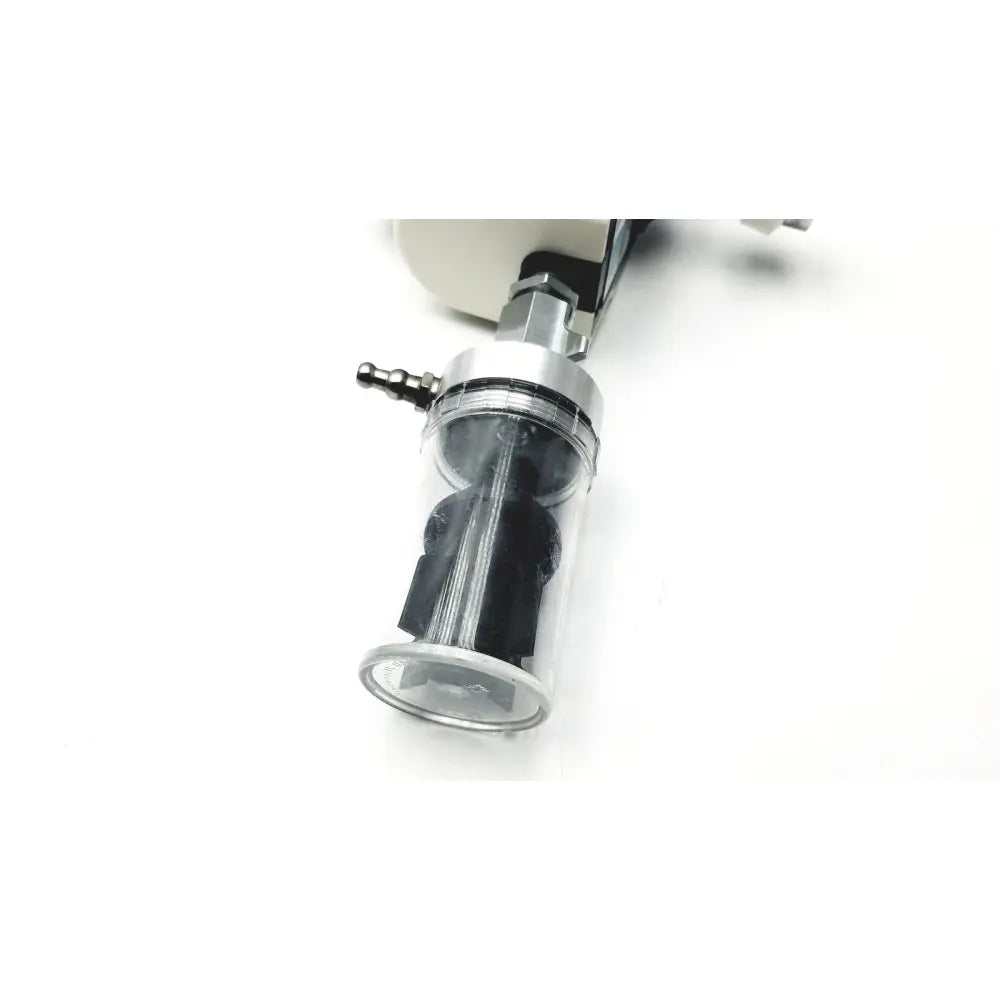 Clear cylindrical air filter with black internal parts and metallic fittings in ohio medical vacuum regulator model 1251