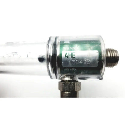 Clear cylindrical ohmeda oxygen flowmeter ahe a30473 with metallic fittings and green serial number label ahe 430473