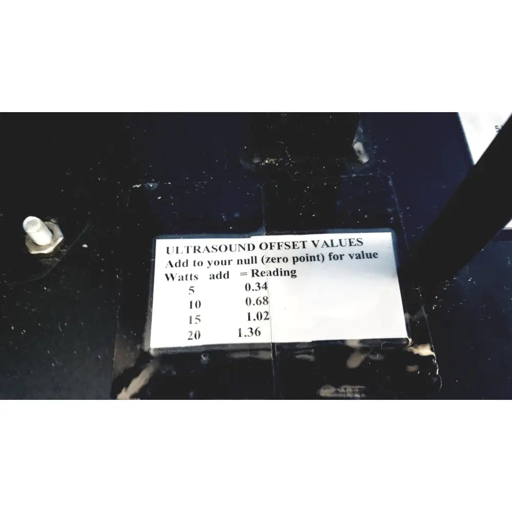 White label with black text displaying ultrasound offset values for calibration on ohmic instruments upm-30 power meter scale