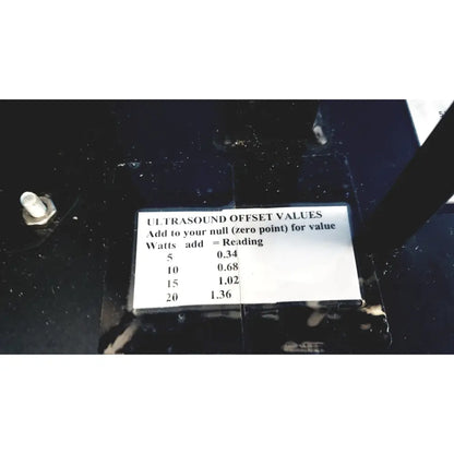 White label with black text displaying ultrasound offset values for calibration on ohmic instruments upm-30 power meter scale