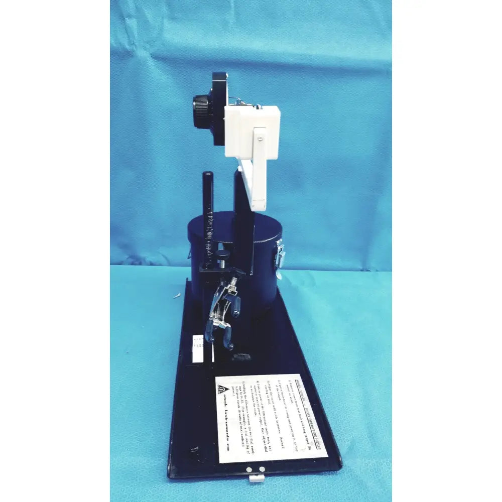 Black and white ohmic instruments upm-30 ultrasound power meter with cylindrical base on adjustable arm power meter scale