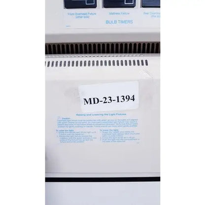 White plastic bulb timer with black labeling and model number md-231394 for olympic medical bili-bassinet phototherapy unit