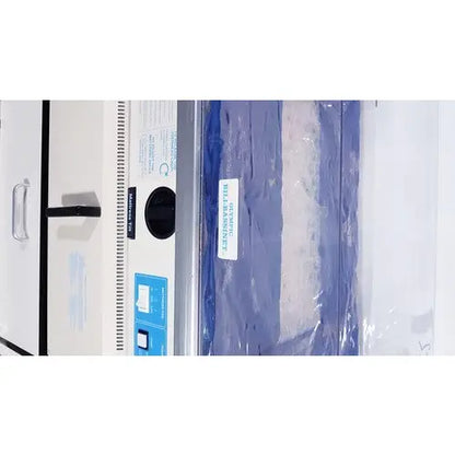 Olympic medical bili-bassinet phototherapy unit with white and silver design and blue sample bag labeled landscape 30