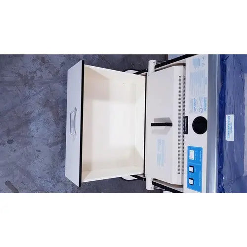 White industrial-grade sterilizer with blue control panel and black handle for olympic medical bili-bassinet phototherapy unit