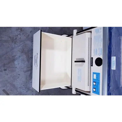 White industrial-grade sterilizer with blue control panel and black handle for olympic medical bili-bassinet phototherapy unit