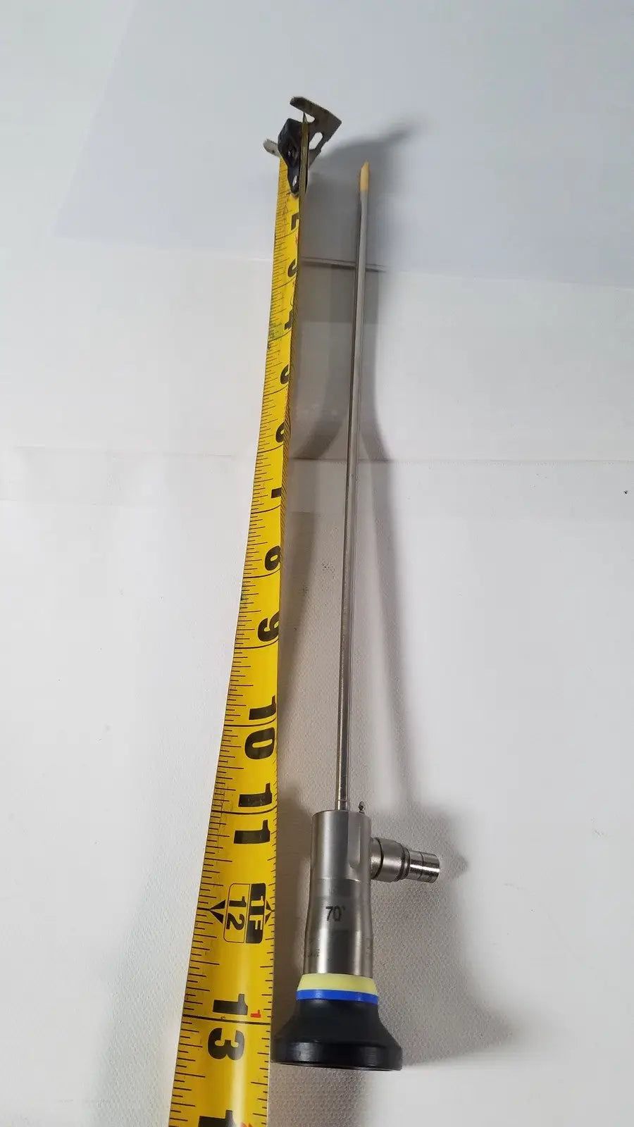 Silver olympus 4mm 70 degree rigid scope with metallic shaft and black yellow base featuring a small camera tip