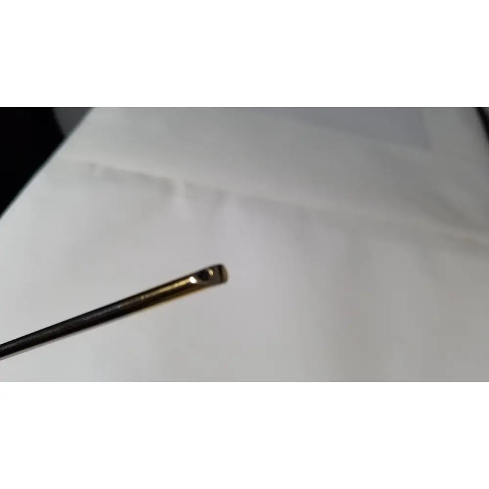 A slender metallic needle with a polished gold eye and dark shaft for the olympus a1933a 4mm 70 degree scope