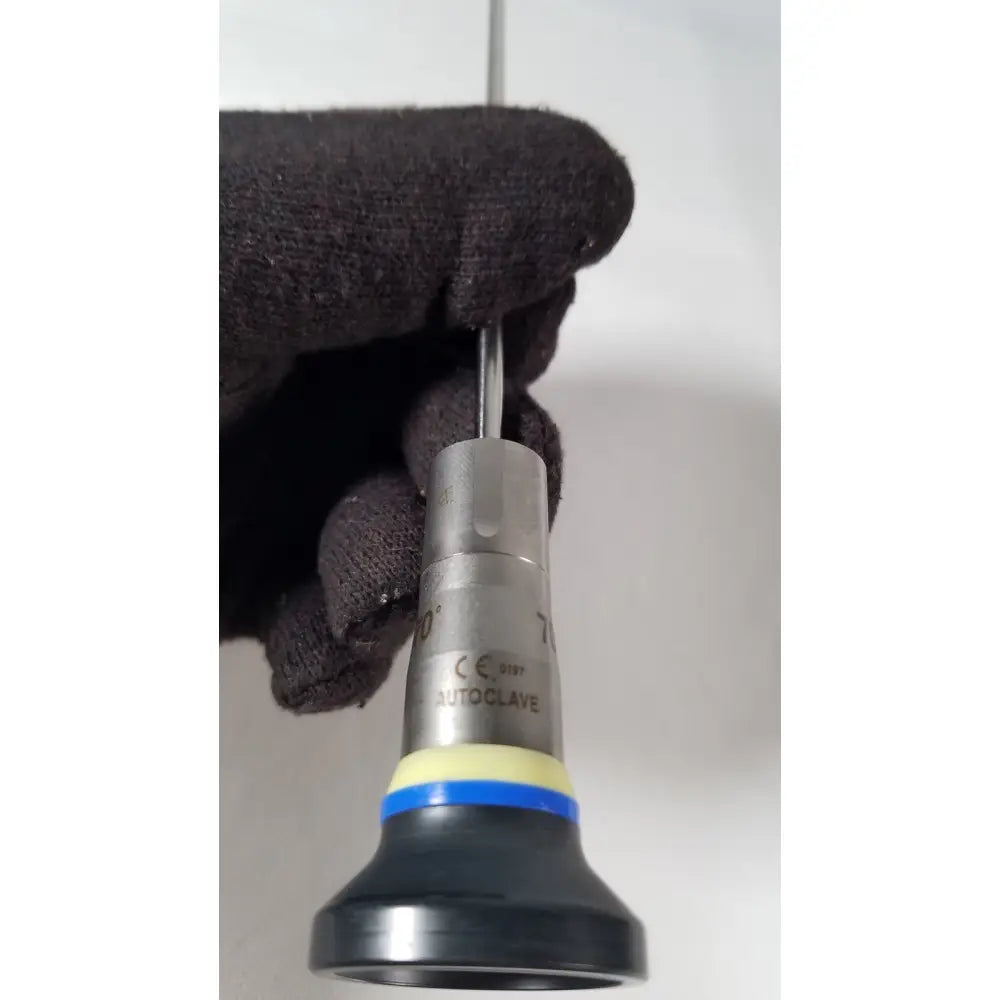 Silver metallic olympus a1933a 4mm 70 degree scope with black rubber grip and blue-yellow band labeled autoclave