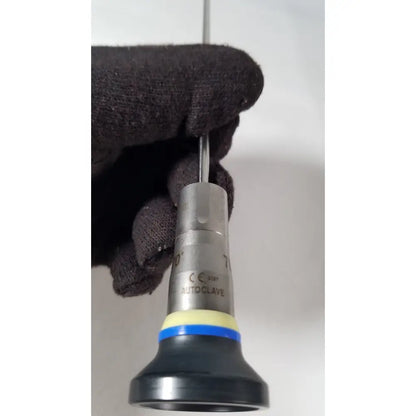 Silver metallic olympus a1933a 4mm 70 degree scope with black rubber grip and blue-yellow band labeled autoclave