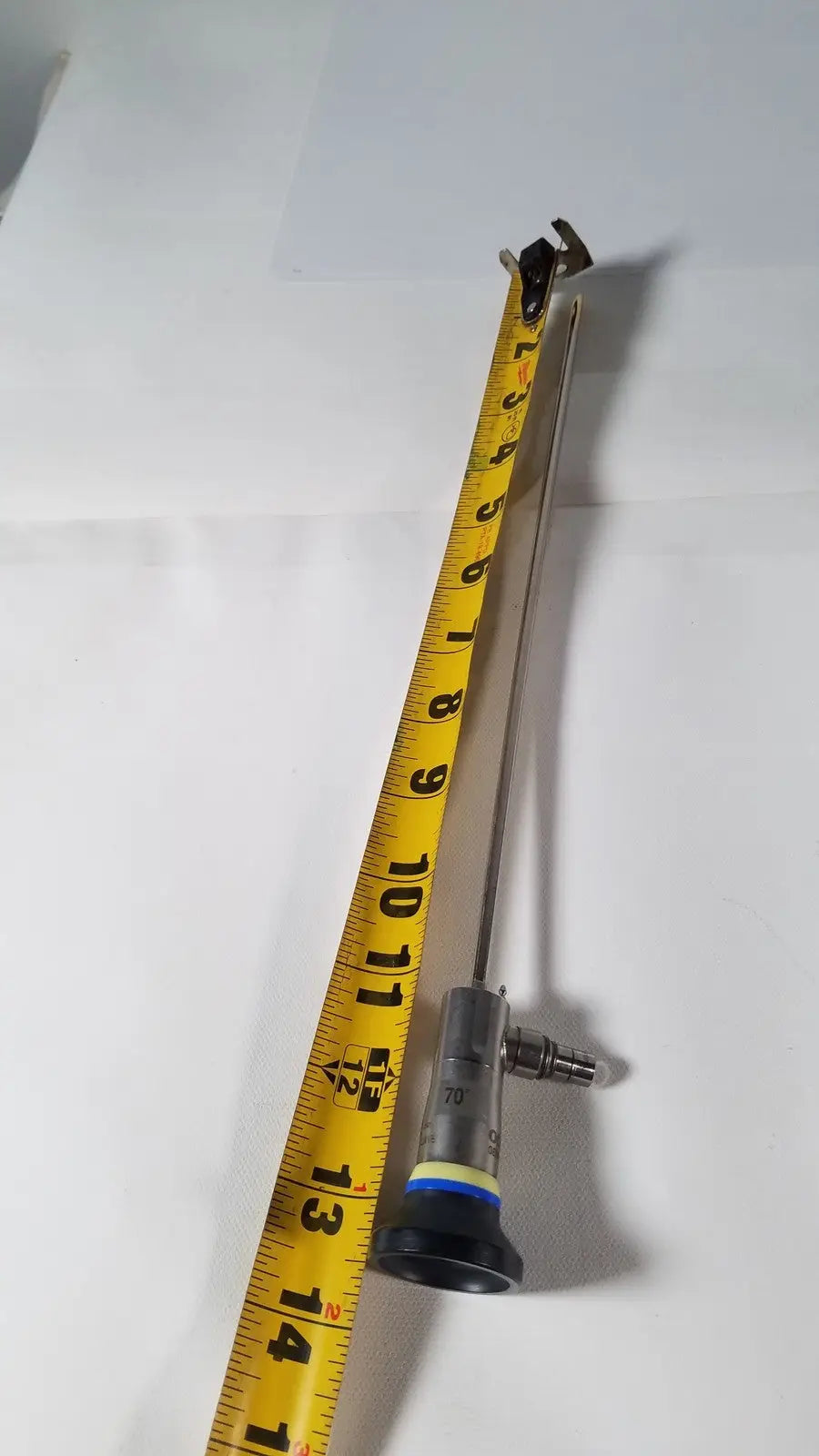 Olympus a1933a 4mm 70 degree metallic endoscope with black and silver body and yellow measurement tape