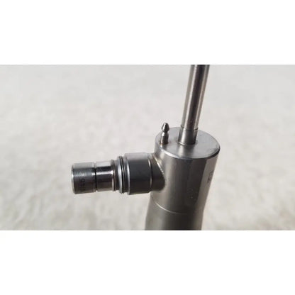 Silver metallic medical-grade syringe with cylindrical barrel and threaded plunger in olympus a1933a autoclavable scope