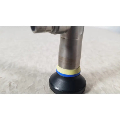 Black rubber suction cup with yellow and blue bands attached to metallic pipe of olympus a1933a autoclavable rigid scope
