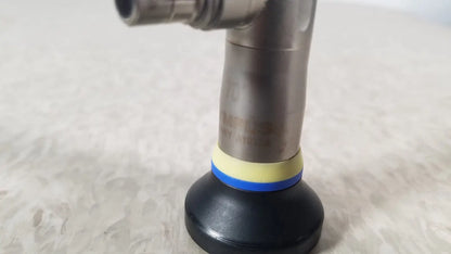 Black rubber suction cup with yellow and blue bands attached to metallic pipe of olympus a1933a autoclavable rigid scope