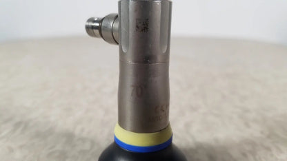 Silver metallic olympus a1933a autoclavable rigid scope with yellow and blue rubber bands around its base