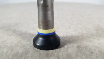 Silver metallic olympus a1933a autoclavable rigid scope with black rubber base and yellow-blue striped accent ring