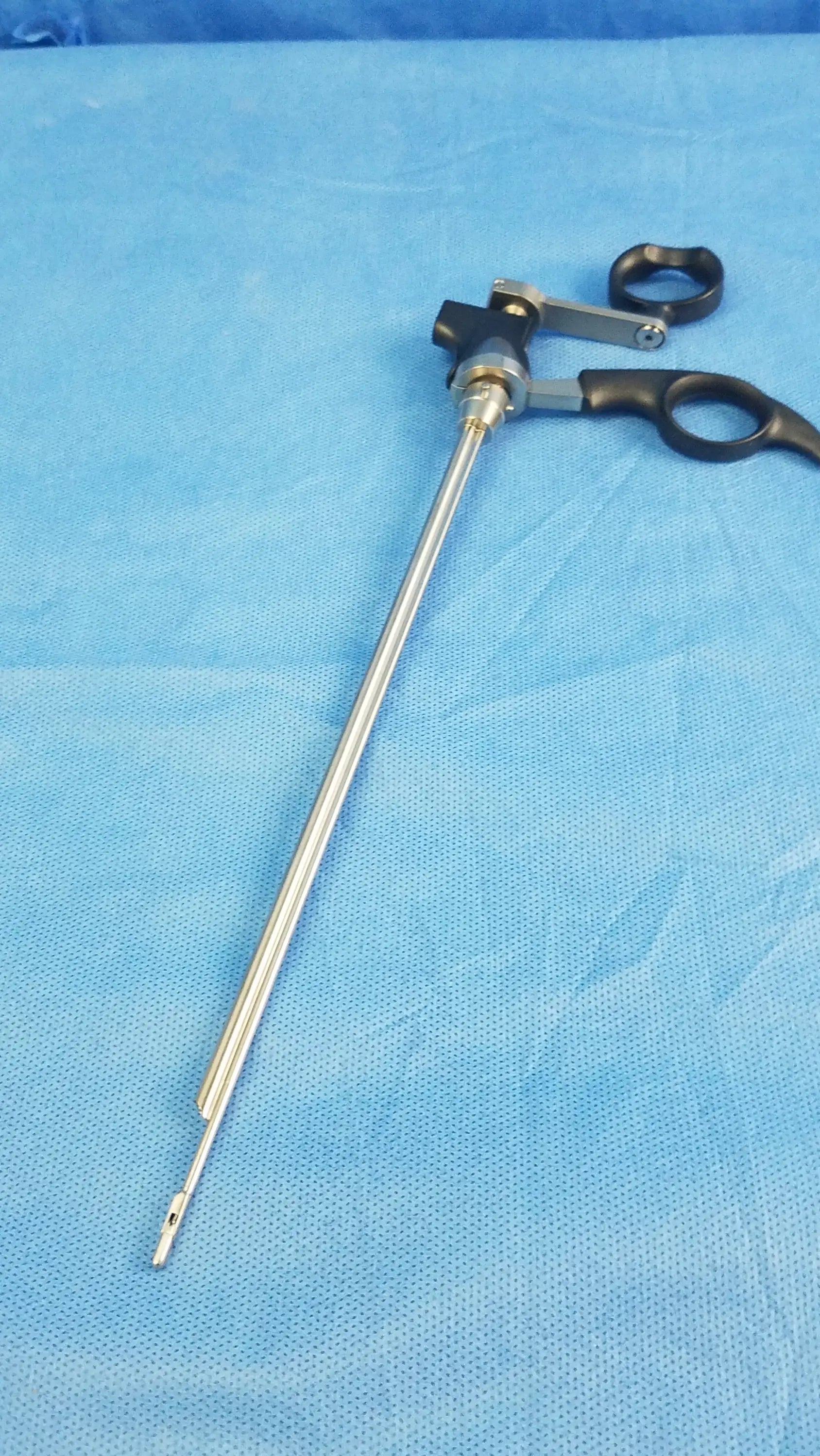 Black-handled olympus a20713a optical biopsy spoon forceps with long slender metallic shaft and articulated joint mechanism