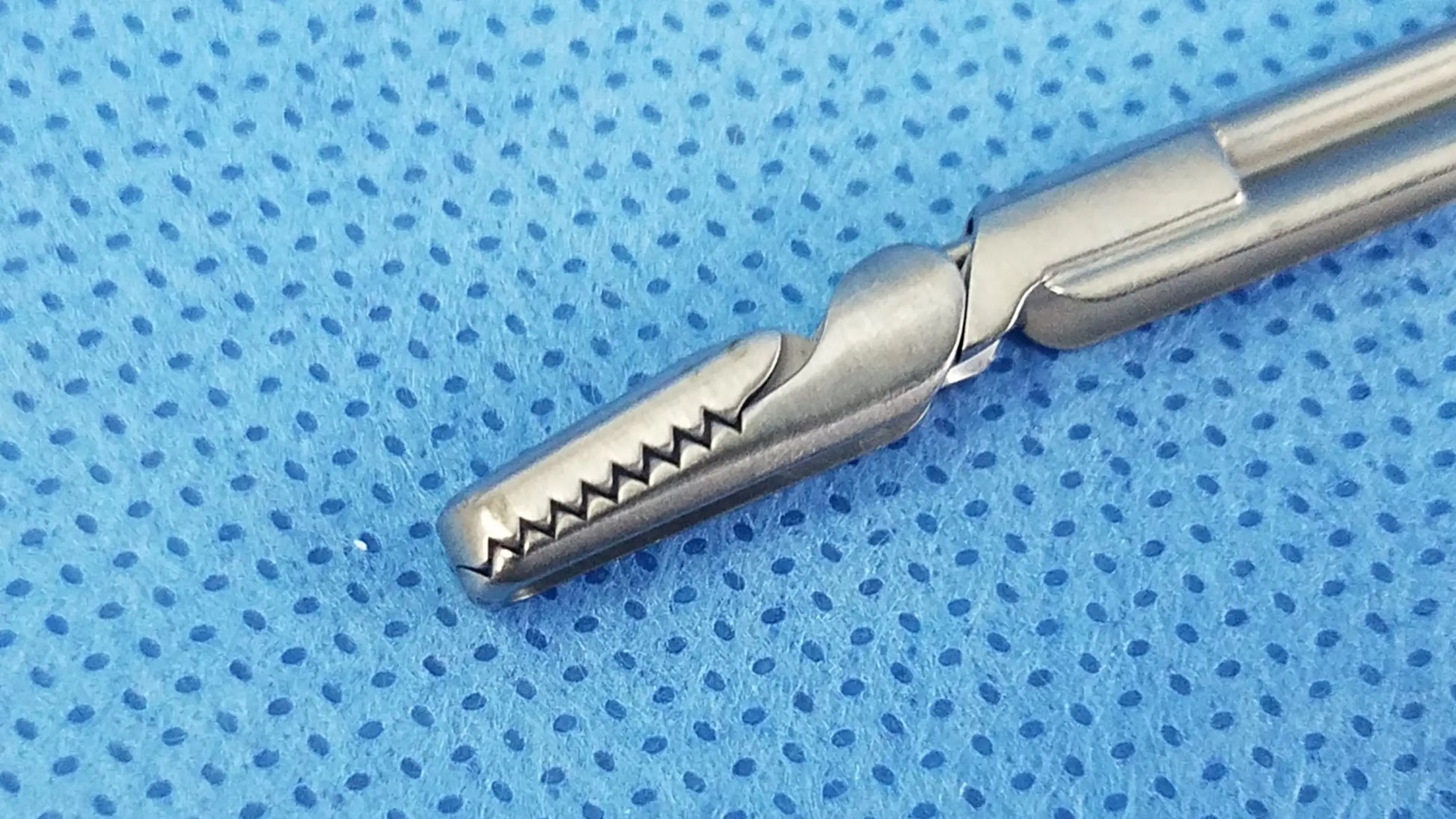 Silver olympus a20718a optical grasping forceps with serrated toothed tip and polished metallic handles