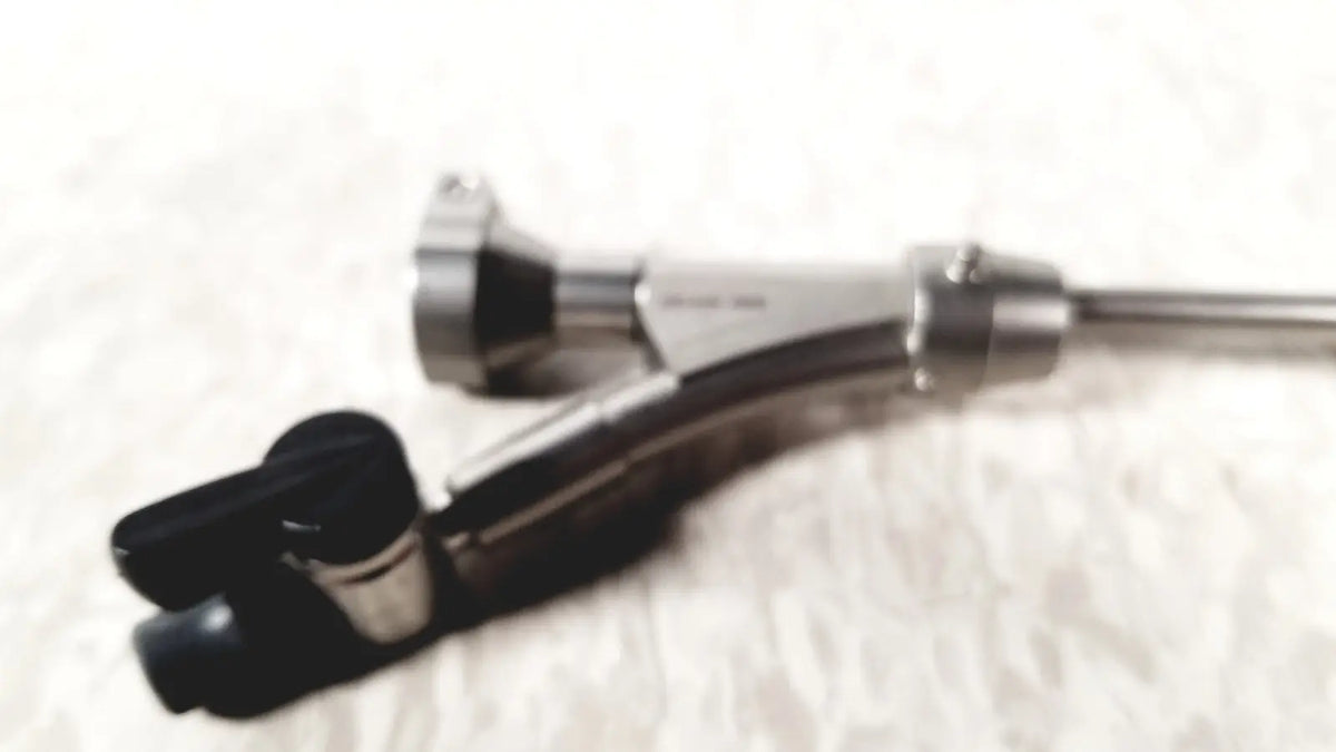 Silver-colored olympus a20975a endoscope bridge with black rubberized grip and articulated joints for medical use