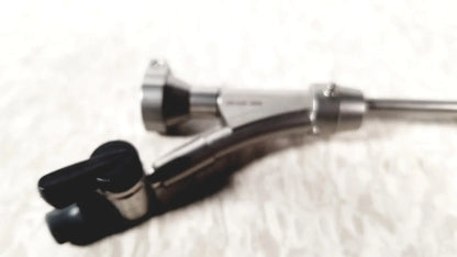 Silver-colored olympus a20975a endoscope bridge with black rubberized grip and articulated joints for medical use