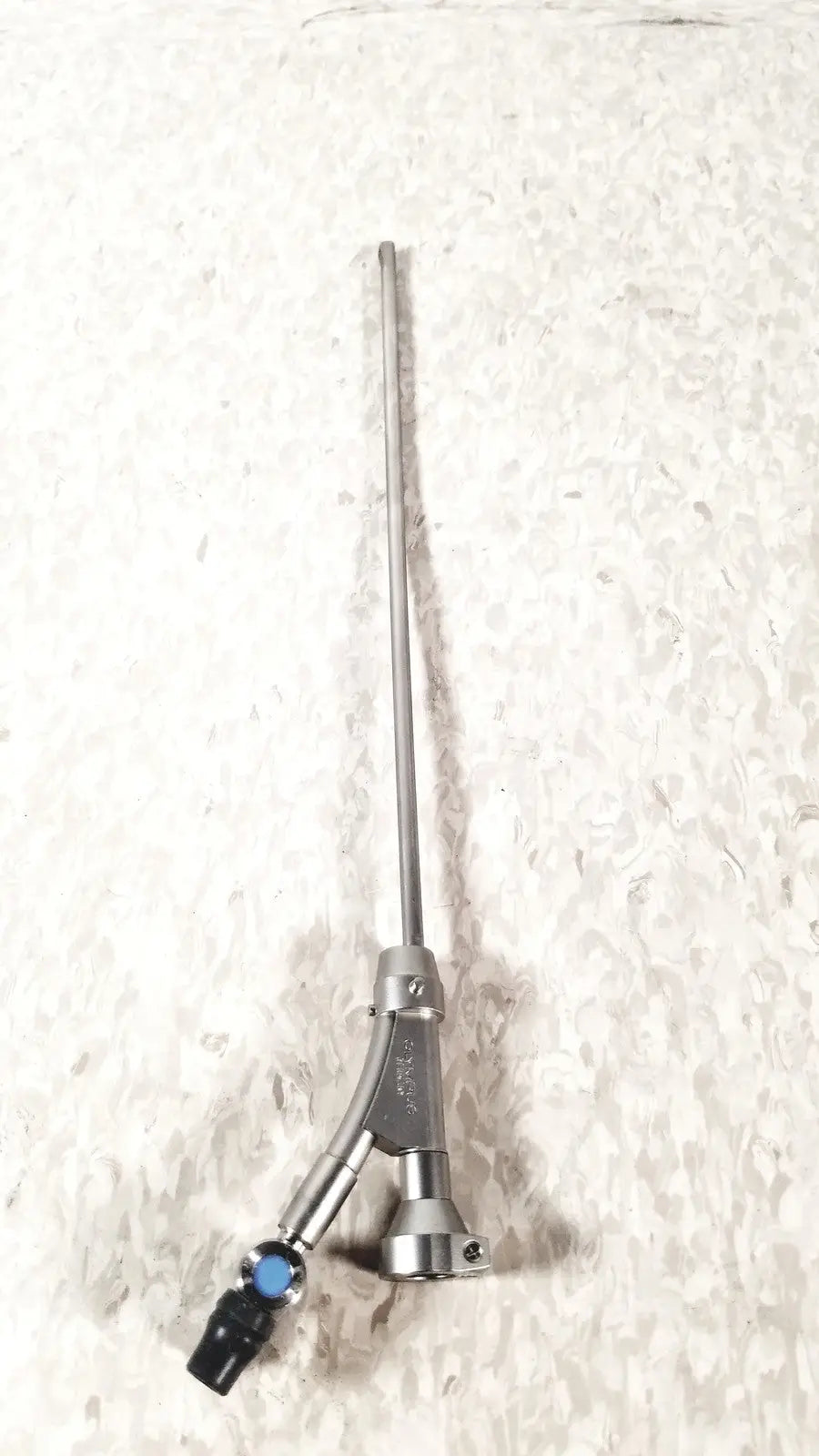Silver surgical instrument with a long slender shaft and y-shaped blue black handle for Olympus a20975a endoscope bridge