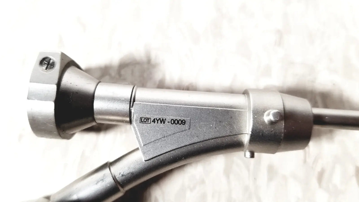 Silver metallic olympus a20975a endoscope bridge with black rubberized grip and engraved model number 4yw-0009 on body