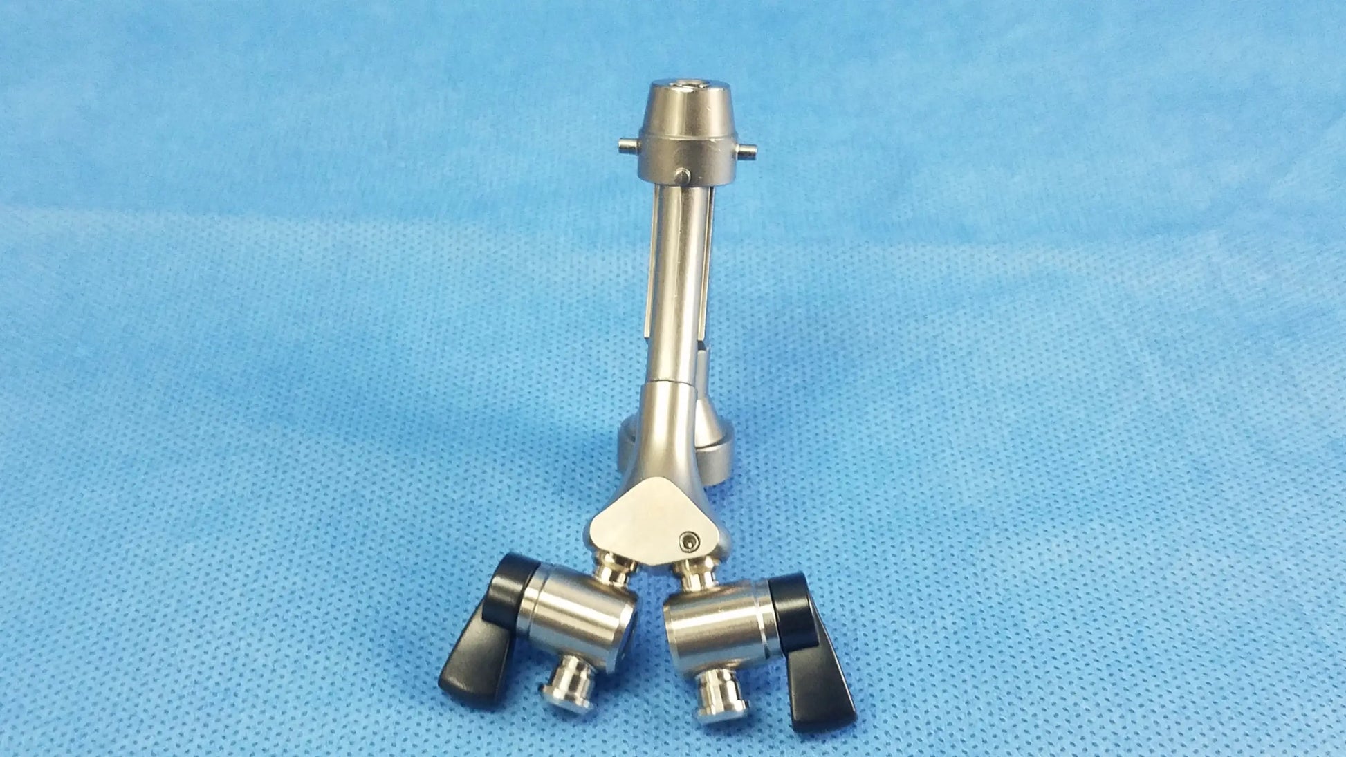 Silver surgical instrument with black ergonomic handles and central joint compatible olympus telescope cysto bridge dual channel
