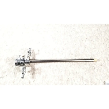 Silver surgical olympus a2181 endoscope with long slender metallic shaft and articulated control knobs at the handle