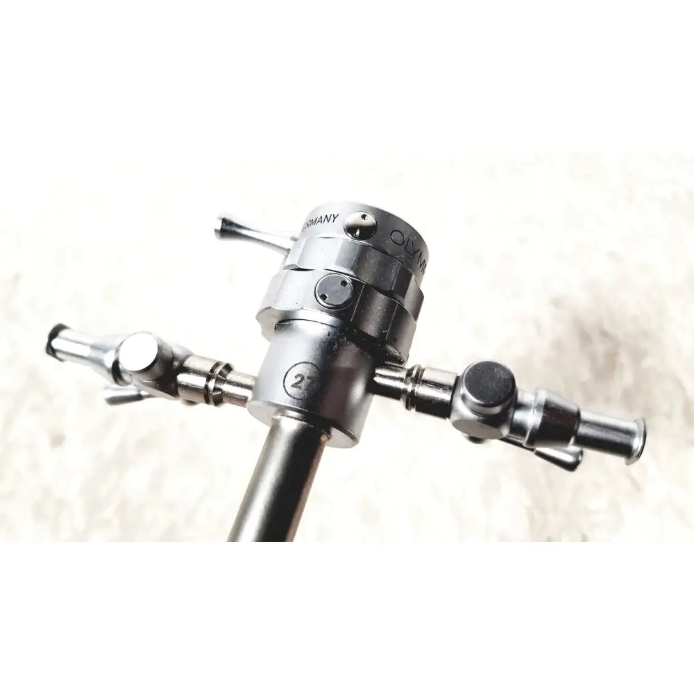 Silver metallic olympus a2181 endoscope sheath with engraved germany branding and three articulated arms design