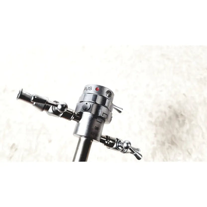 Silver metallic olympus a2181 endoscope sheath with cylindrical body and dual articulated arms with spherical joints