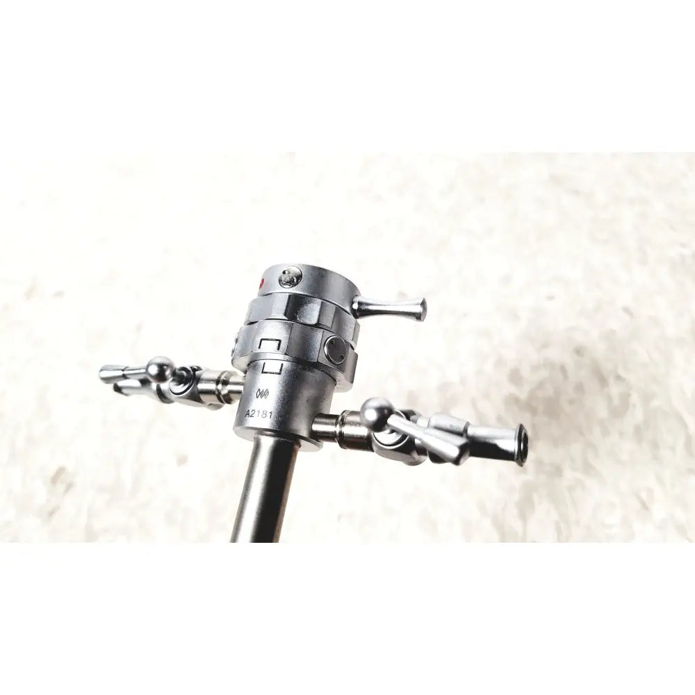 Silver metallic olympus a2181 endoscope sheath with 27fr featuring a central shaft and three precision-tipped articulated arms